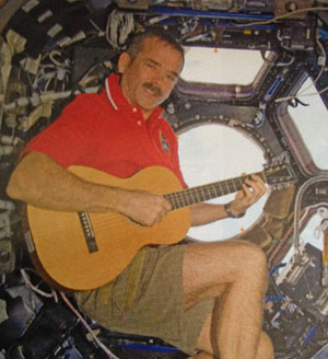 Chris Hadfield on guitar in spacecraft.