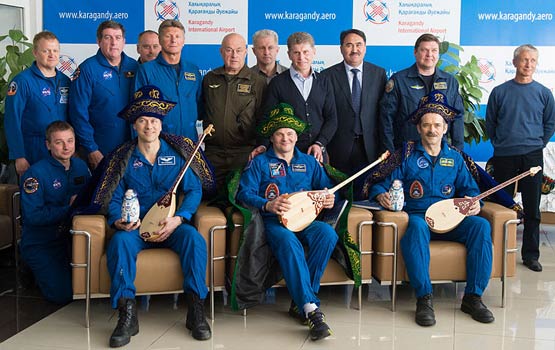 Traditional Kazakhstan dress during a welcome ceremony, Chris Hadfield (right), Russian Roman Romanenko and Tom Marshburn, left.