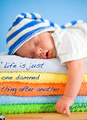 New born baby asleep on soft towels with funny birthday quote.
