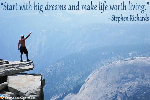 Man standing on overhanging rock looking into mountainous scenery with motivational quote.